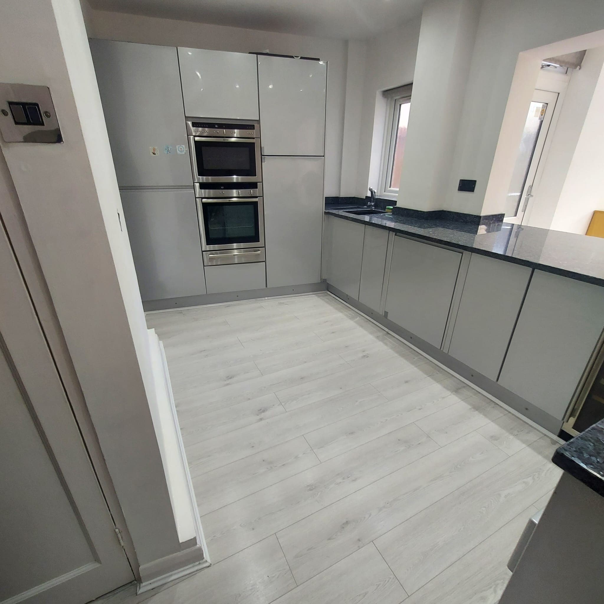 Cleaner dusting a bright London home