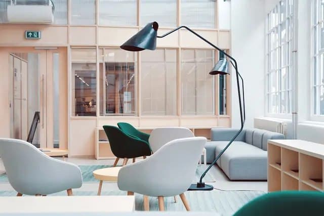Cleaner dusting a bright London home